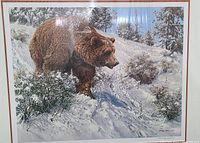 Frontal photo of framed art print showing the bear in snowy landscape and the wood-tone frame with double matting.