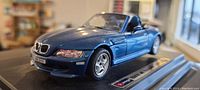 Front and side view of the blue BMW M Roadstar diecast model on black display base