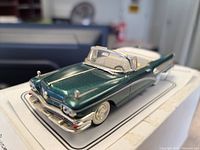 Front angled view of green metallic die-cast Dinky Buick model car showing detailed front grille, headlights, and bumper.