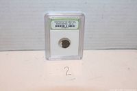 Frontal image of coin in slab with label stating authenticity and era