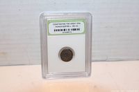 Front view of the slabbed Roman coin showing the authenticity label and coin details.