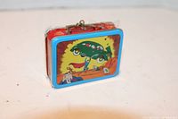 Mini lunchbox ornament with cartoon car graphic