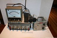 Photo showing HP 8602B RF Signal Generator, 3 microphones, an HP 185A Amplifier, and an analog scale meter