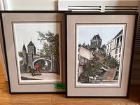 Two framed horse and carriage prints, each 9x6 inches, leaning against a wall showing details of the art and framing.