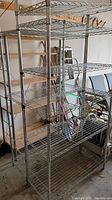 Overall view of both chrome wire shelving units in garage setting