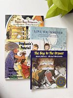 Four Robert Munsch children's books arranged together showing titles and illustrated covers.