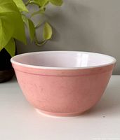Side view of vintage pink Pyrex mixing bowl showing exterior condition and shape