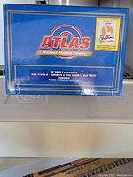 Blue Atlas branded box showing labeling for 0 scale GP-9 locomotive model, Baltimore & Ohio 6468, with Lionel RailSounds logo.