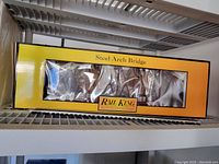 Rail King Steel Arch Bridge in original box with yellow and black labeling.