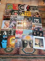 Overhead shot showing entire collection of vinyl LP records arranged on tile floor