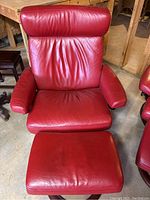 Front view of red leather recliner and ottoman