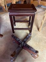 Top angled view showing wooden table surface with slight scratches and dark polished wood.