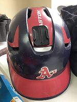Top front view of Easton baseball helmet showing dark blue and red finish with 'A's logo on the front visor and center top strap area.