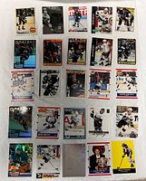 Top side front view of 25 Wayne Gretzky hockey cards arranged in a grid on a flat surface, showing a variety of Gretzky images and card designs.
