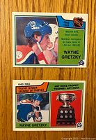 Front side of two Wayne Gretzky hockey cards from 1982-83 NHL series, showing player images and achievement highlights.