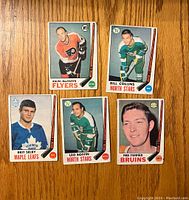 Five hockey cards front side with player portraits and team names