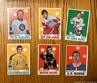 Front view of six vintage 1970-71 O-Pee-Chee hockey cards showing portrait photos of players in team uniforms with colored backgrounds.