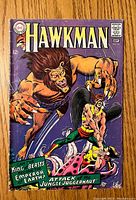 Front cover of Hawkman comic issue #21 featuring a jungle attack scene with Hawkman fighting a large beast.