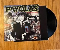 Front cover of The Payolas Hammer on a Drum album with vinyl partially showing