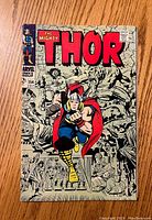 Front cover of The Mighty Thor issue #154 featuring Thor in color with crowd background in grayscale.