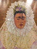 Close-up of Frida Kahlo image with Diego Rivera on forehead and floral headdress details
