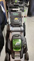 Top view of EGO Power+ LM2000 walk-behind lawn mower showing handle, battery compartment with green cover, and cutting deck.