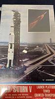 Box art showing the Apollo/Saturn V Launch Platform Tower and Crawler Transporter Rocket on the launchpad with launch flames in the inset, box sealed in original plastic wrap.