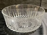 Side view of clear vintage Arcoroc crystal bowl showing diamond cut pattern and starburst base design.