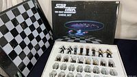View of the chess board, box, and Star Trek themed figurine chess pieces arranged inside the box insert