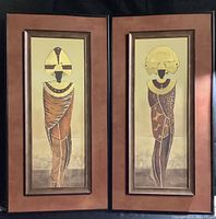 Pair of Inka-themed textured gold wall art pieces side by side in double brown-orange frames with visible staining and wear.