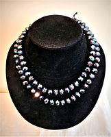 Front view of the faceted crystal bead necklace displayed on a black velvet bust, showing the bead size and shine.