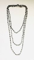 Full view of the long grey quartz faceted bead necklace showing its length and design.