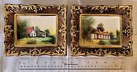 Pair of pottery wall plaques showing both plaques side by side with a ruler for scale.