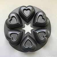 Top view of Wilton Six Hearts Cake Pan showing six heart-shaped molds and star center.