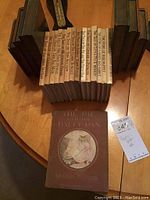 All books arranged on table between bookends, spines facing forward