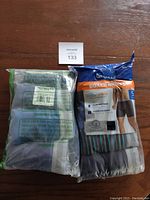 Two packs of Gildan boxer briefs in size 2XL, still in original sealed packaging with one pack showing multiple colors including grey and multi-color stripes.