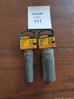 Photo showing two Dewalt deep impact sockets with 1/2 inch and 7/8 inch sizes, alongside their original Dewalt tags.