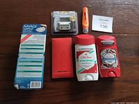 All 6 men's care items laid out including Navage SaltPod box, Old Spice deodorants, grooming tool attachment, and red box.