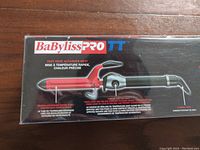 Box front view showing BaBylissPRO TT label and image of curling iron with heat settings