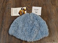 Top view of blue fur skull hat beanie illustrating texture and color.