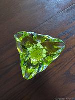 Top-down view showing the irregular triangular shape and transparent green glass with clear accents.
