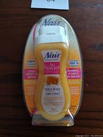 Photo of Nair Au Naturel Milk & Honey hair removal lotion in sealed packaging showing front label and branding.