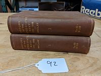 Two volumes of 'History of the United States Navy 1775-1898' stacked with spines facing out, showing title, author Maclay, volume numbers, and library call numbers.