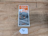 Front view of folded brochure showing title 'Along the Union Pacific System' with illustration of train and mountains