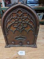 Full front view of antique Echophone radio in Gothic cathedral style wooden cabinet showing the intricate carved grill and overall cabinet.