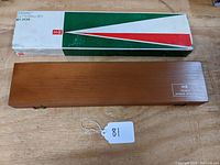 Wooden case labeled Keuffel & Esser Doric Lettering Set, closed, showing overall condition