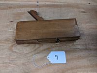 Wooden molding plane flat view showing top profile and wood grain.