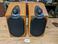 Front view of both speakers with grille covers installed showing B&W logo and Nautilus tweeters.
