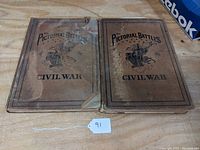 Front covers of two hardcover books titled 'The Pictorial Battles of the Civil War' showing age wear, tears, and stains.