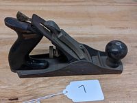 Side angled view of the Stanley Handyman H1203 woodworking plane showing metal blade and wood handle.